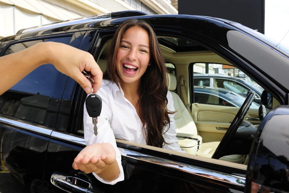 Driver receiving the keys to her new car