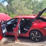 Red Kia EV6 GT-Line exterior rear side veiw with doors open