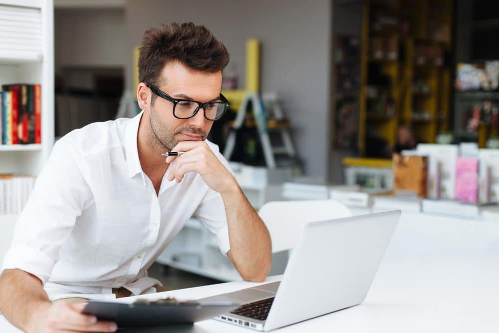 Man checking how much he can borrow to buy a business on his laptop