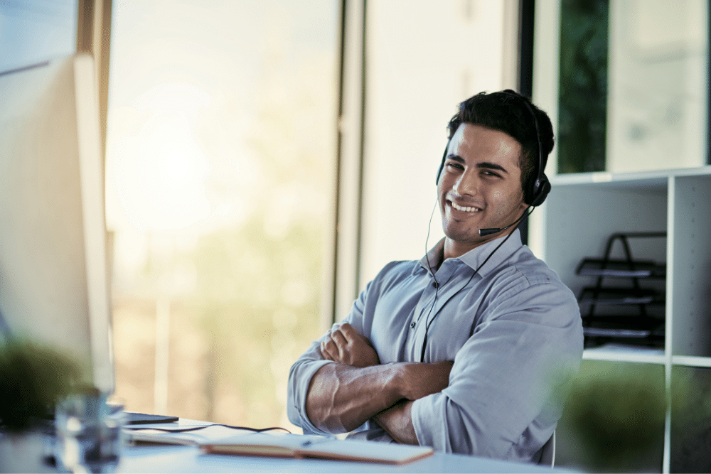 Car finance broker at desk wearing headset