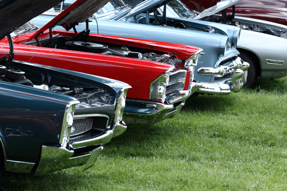 Car Loans Banner - Vintage cars parked in a row on grass