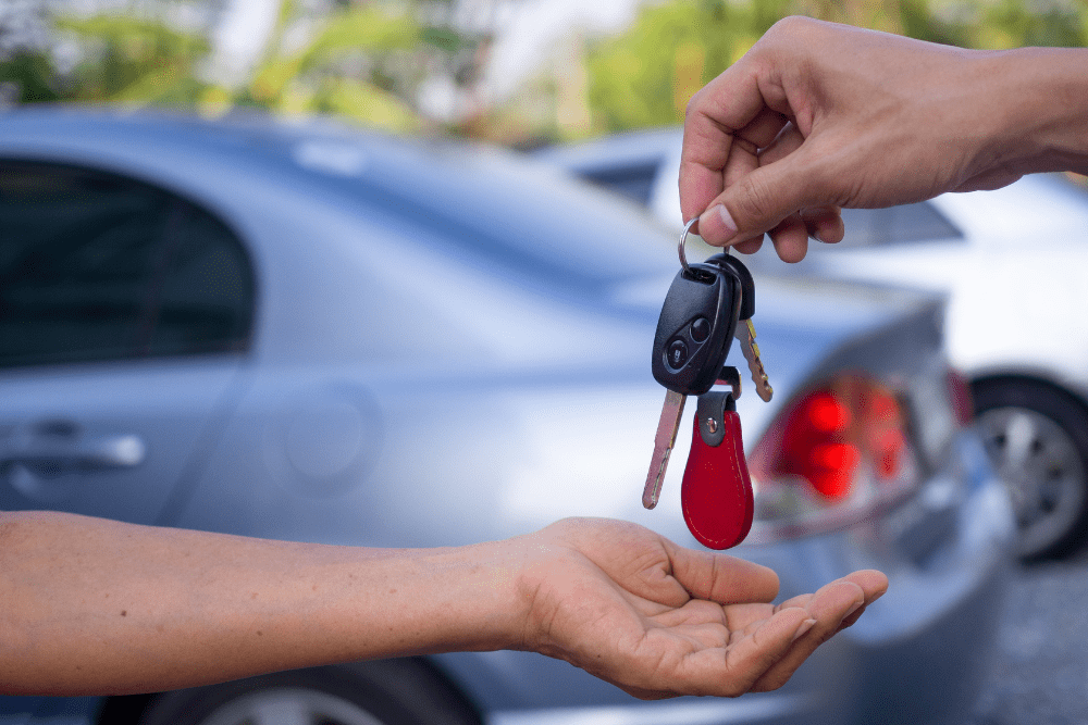 Car Loans Banner - Car buyer being handed the keys to their used, private-sale car