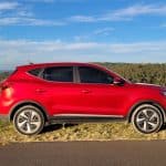 Red 2023 MG ZS EV parked on side of road