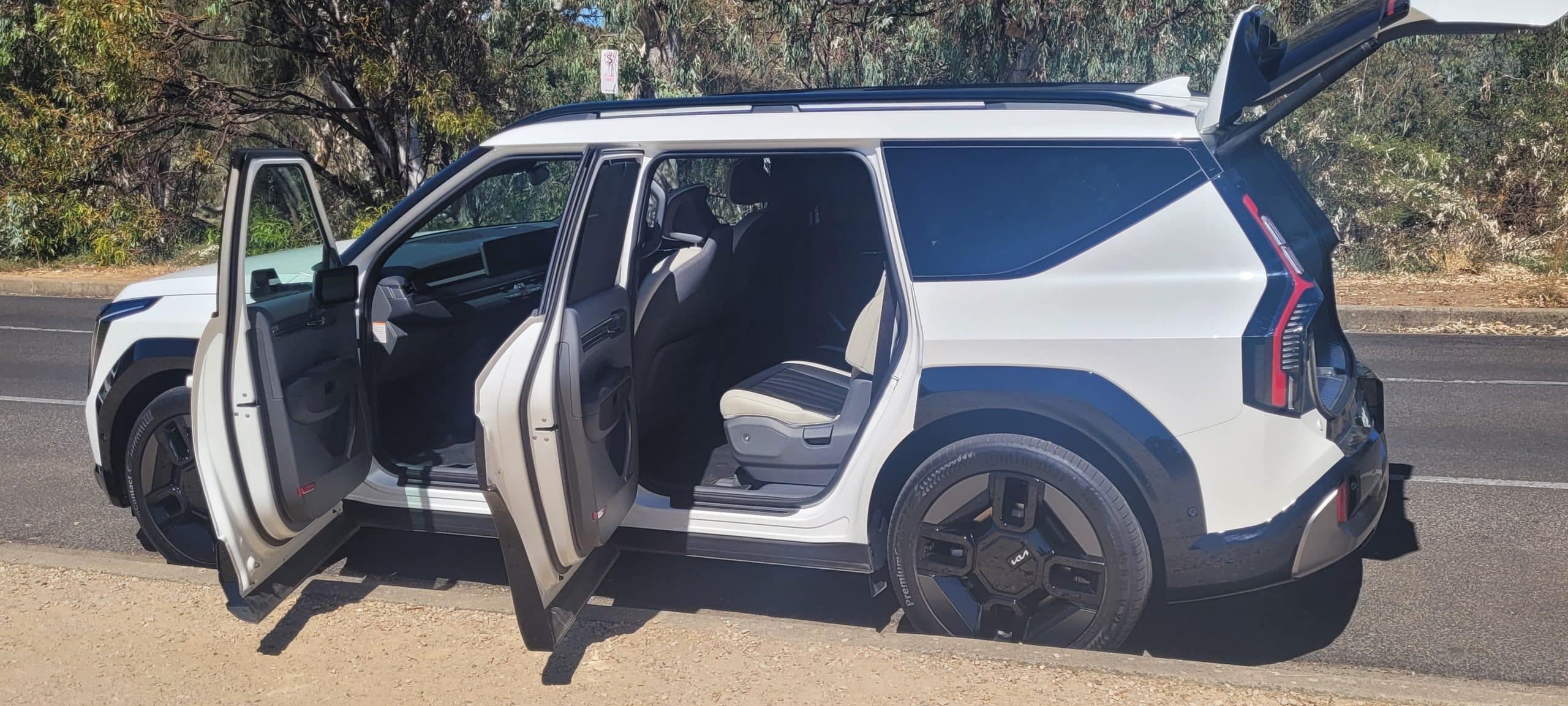 White Kia EV9 side view with doors open