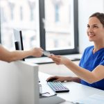 Health care professional receiving a patient's health insurance card