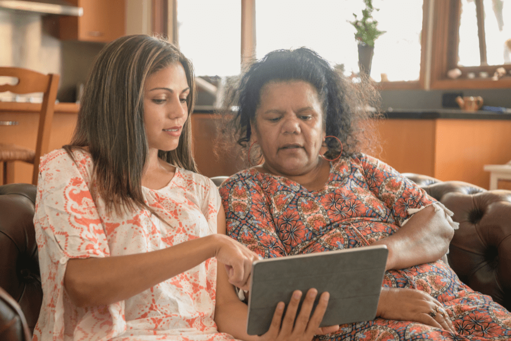 Car Loans Banner - Two Aboriginal women looking at a tablet together