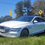 Matte White 2024 Genesis G80 electric front angle view on street