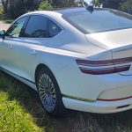 Matte White 2024 Genesis G80 electric rear quarter panel view