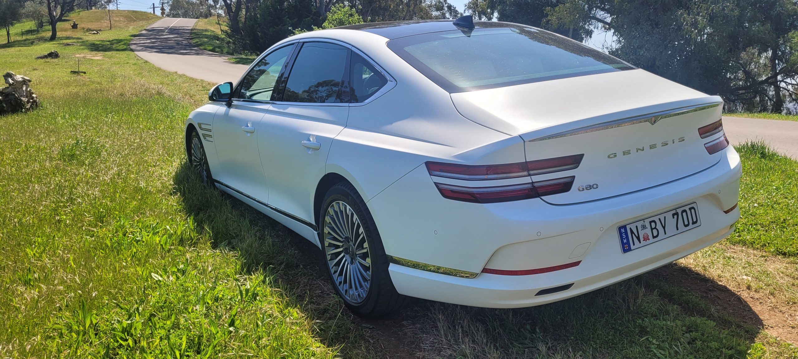 Matte White 2024 Genesis G80 electric rear quarter panel view