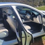 Matte White 2024 Genesis G80 EV side view with doors open.