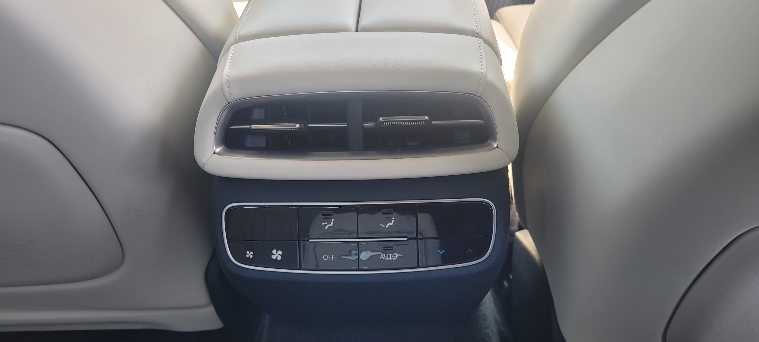 Rear centre console AC outlet and controls on Genesis G80 EV.