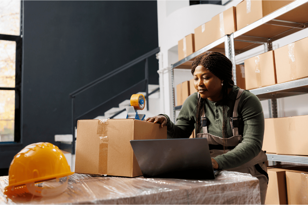 Woman logging assets in business stockroom