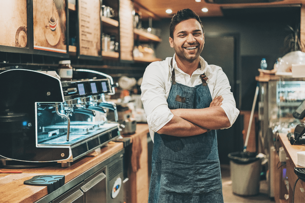 Barista smiling inside a cafe