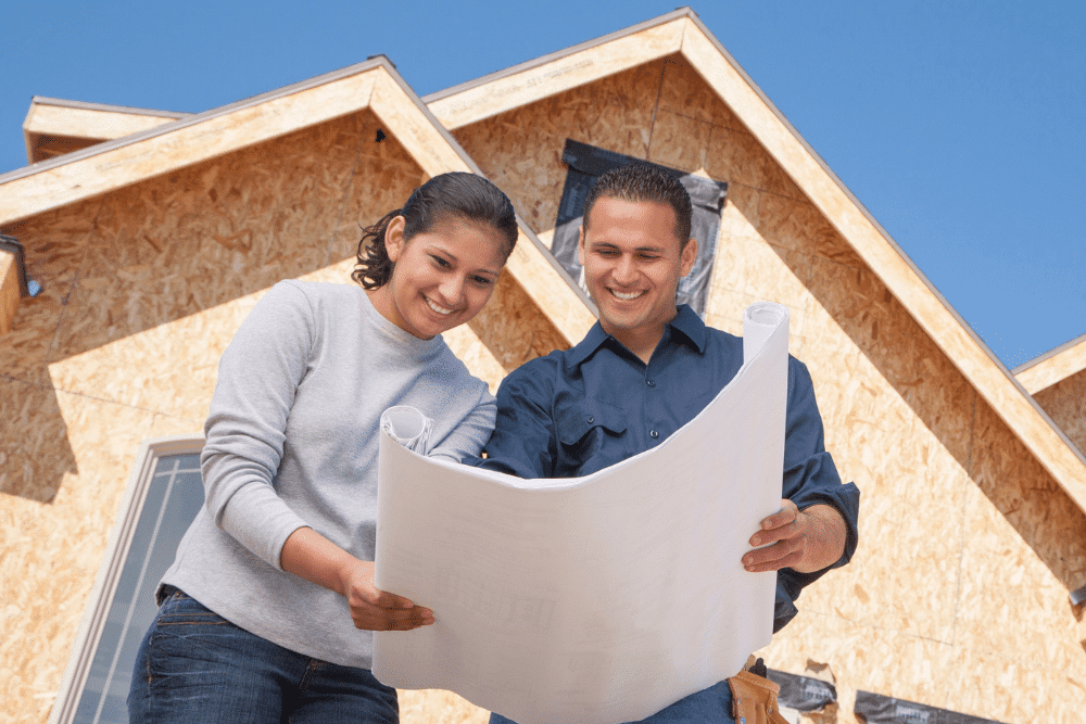 Couple looking at plans for their home construction