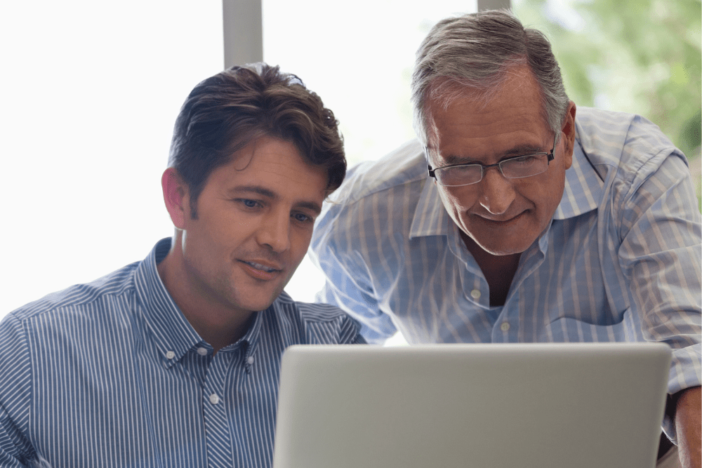 Man looking at a computer with his father