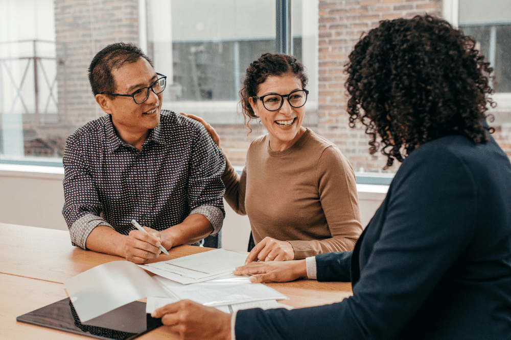 Couple signing a contract with a mortgage specialist