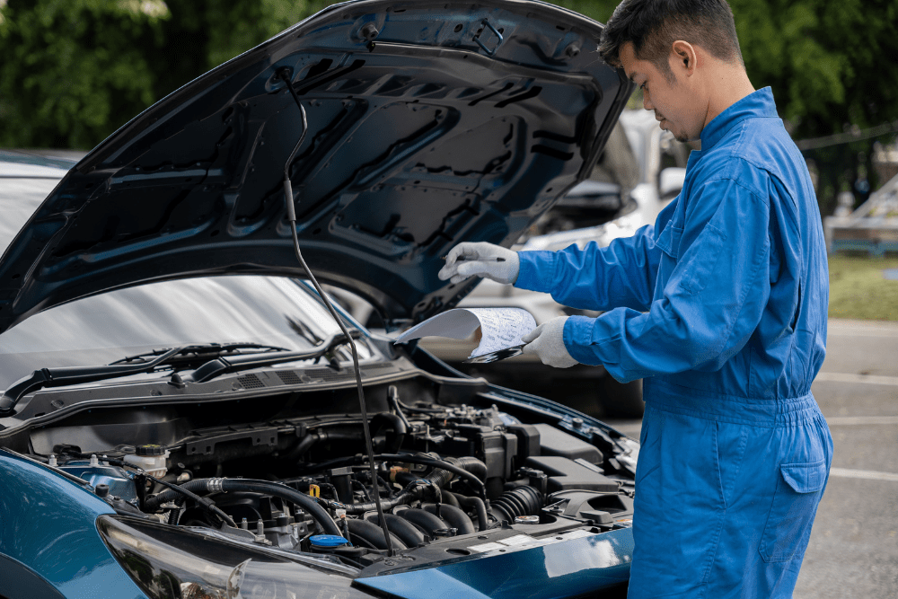 Mechanic inspecting the engine of a car