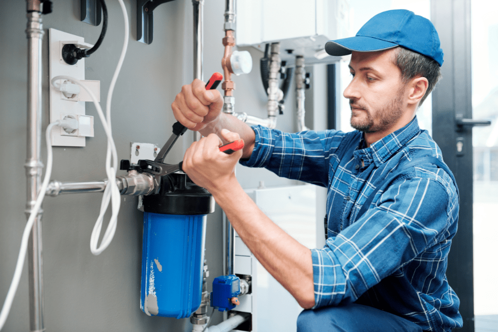 Plumber fixing tubing with a wrench