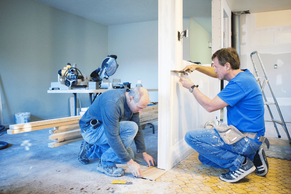 Tradesmen completing renovations inside a home