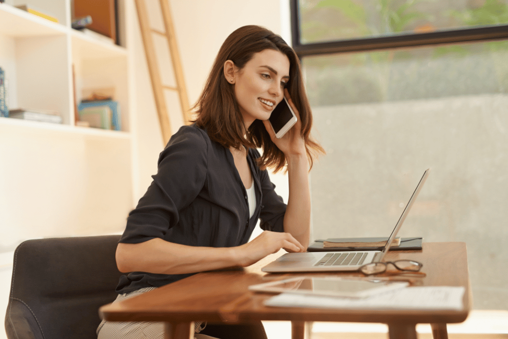 Businesswoman on the phone at her desk at home