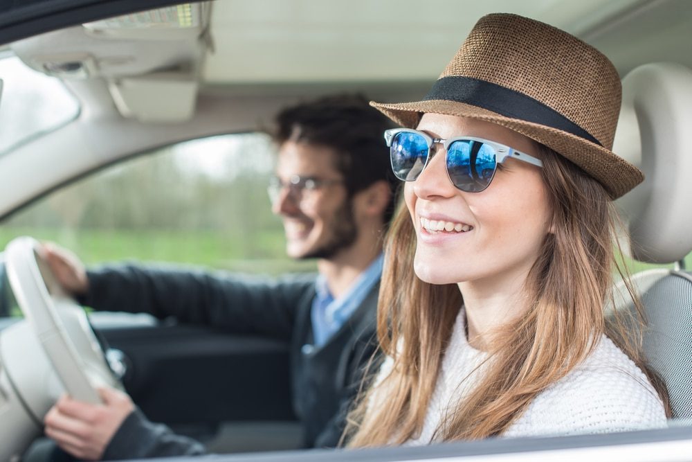 Happy couple driving in car