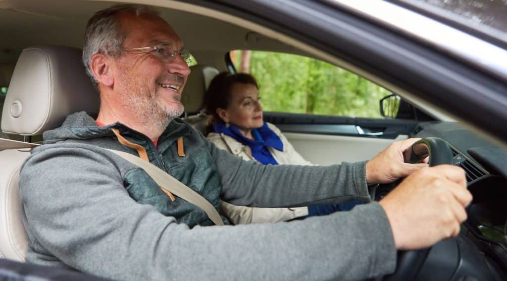 Senior couple driving in their car