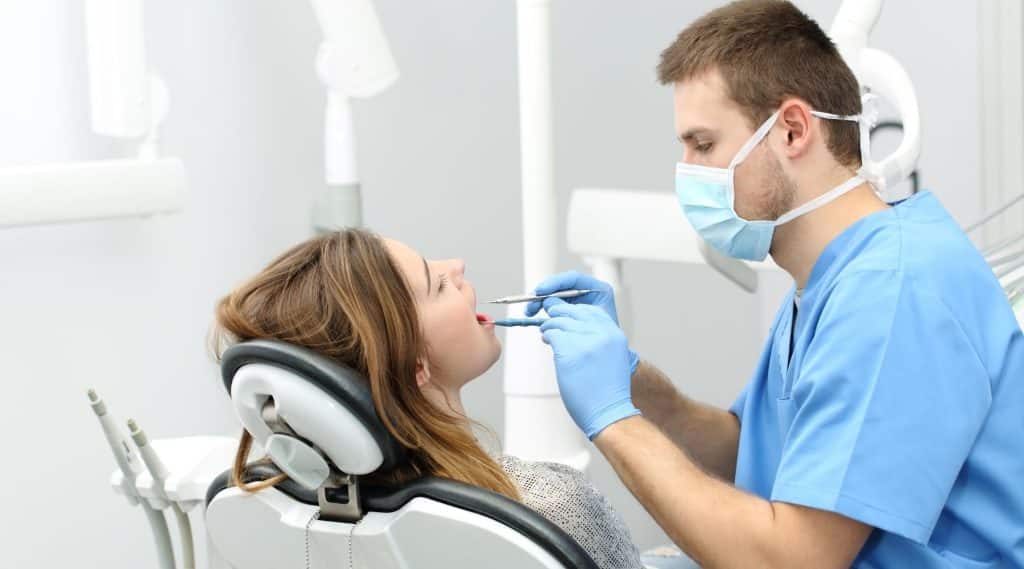 Woman having her teeth checked by her dentist