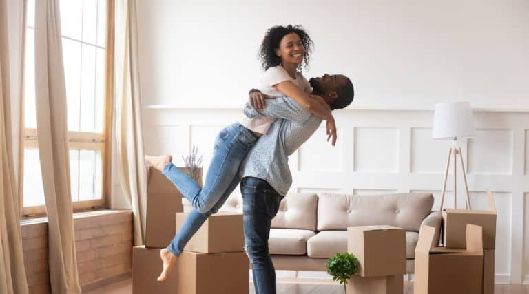 A happy couple moving into their first home