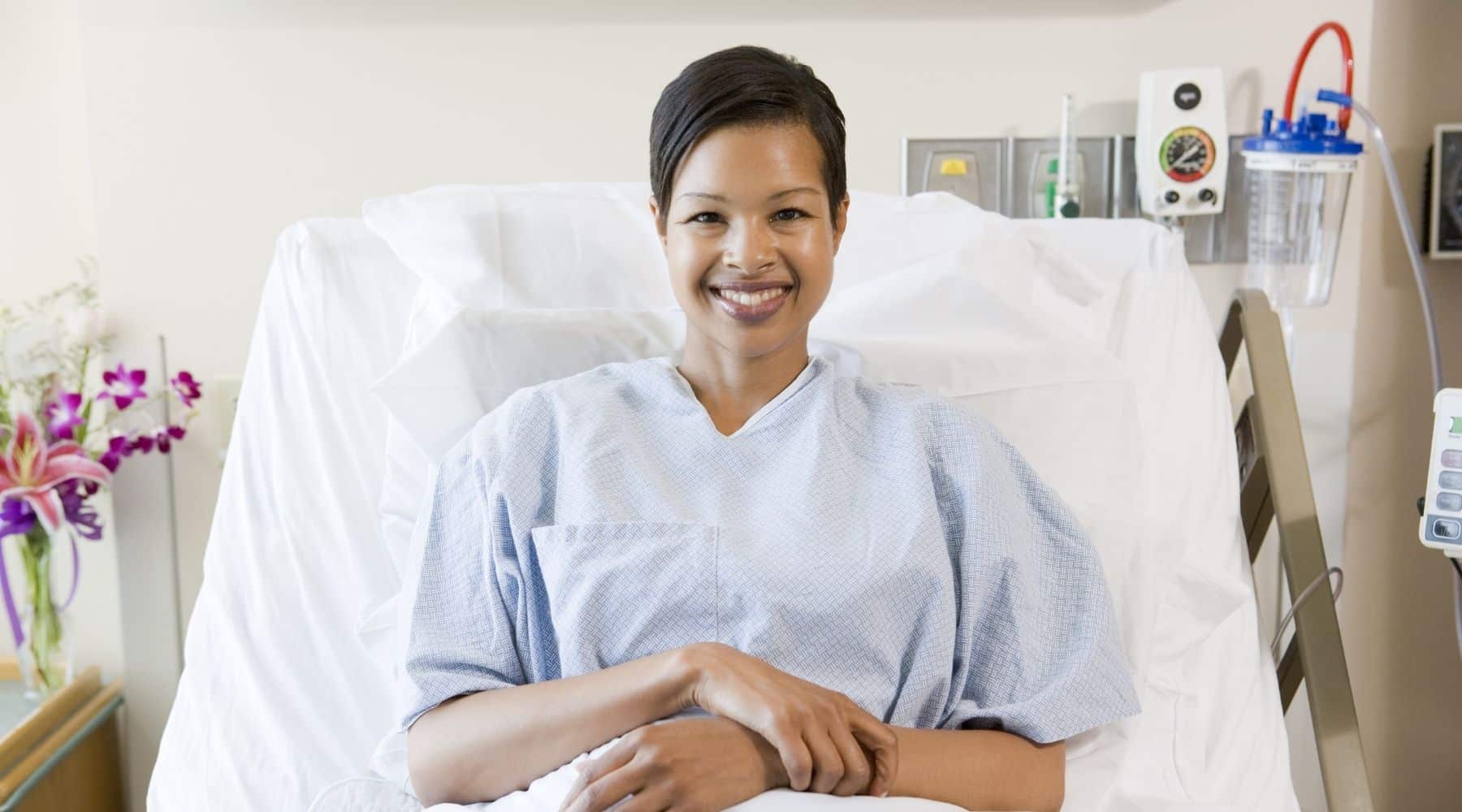 Happy woman in hospital bed