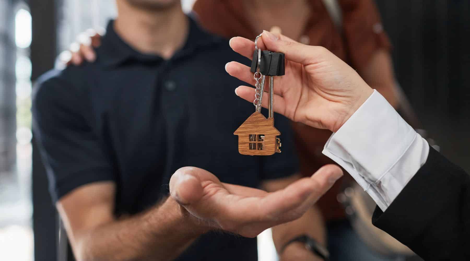 Couple receiving keys to their new house