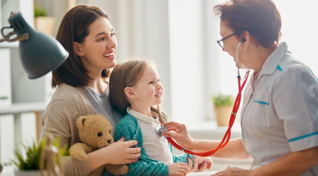 A girl having a check-up with a health practictioner