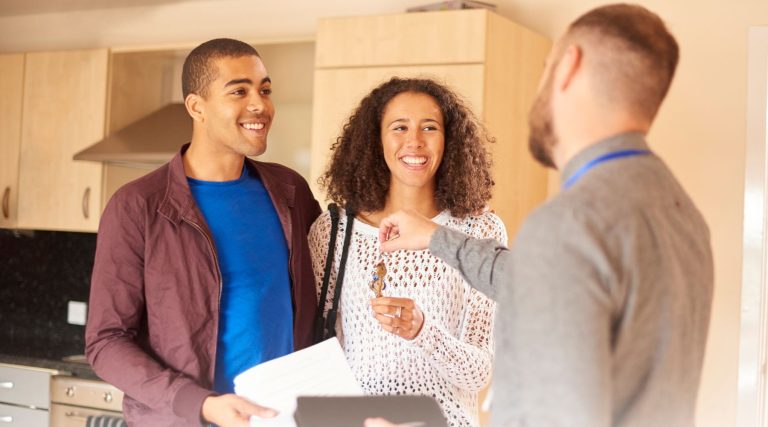 Happy tenants receiving the keys to their property