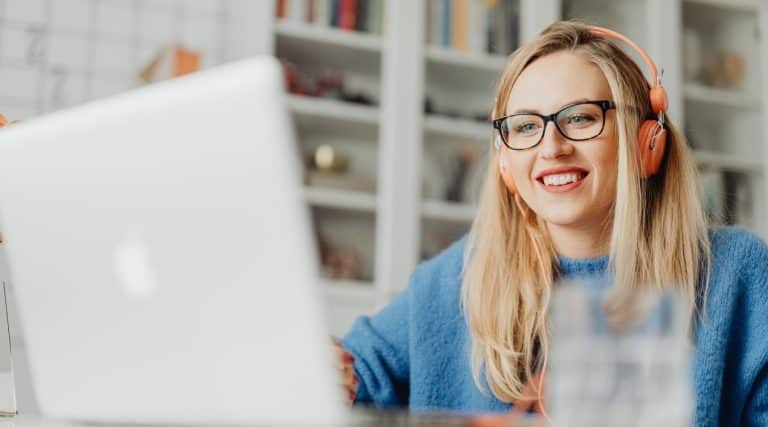 A smiling woman using her laptop