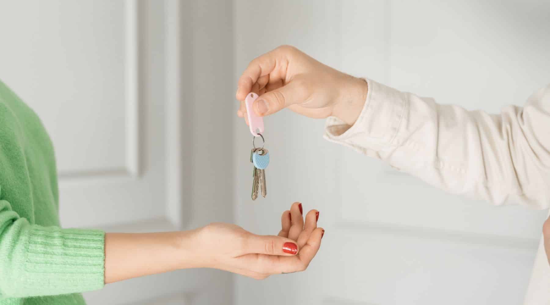 Two people exchanging house keys