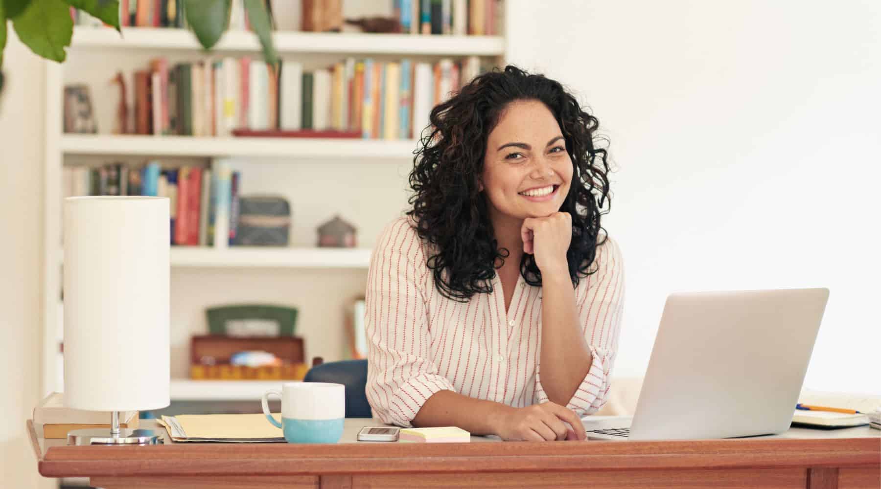 Woman at her desk with a laptop.
