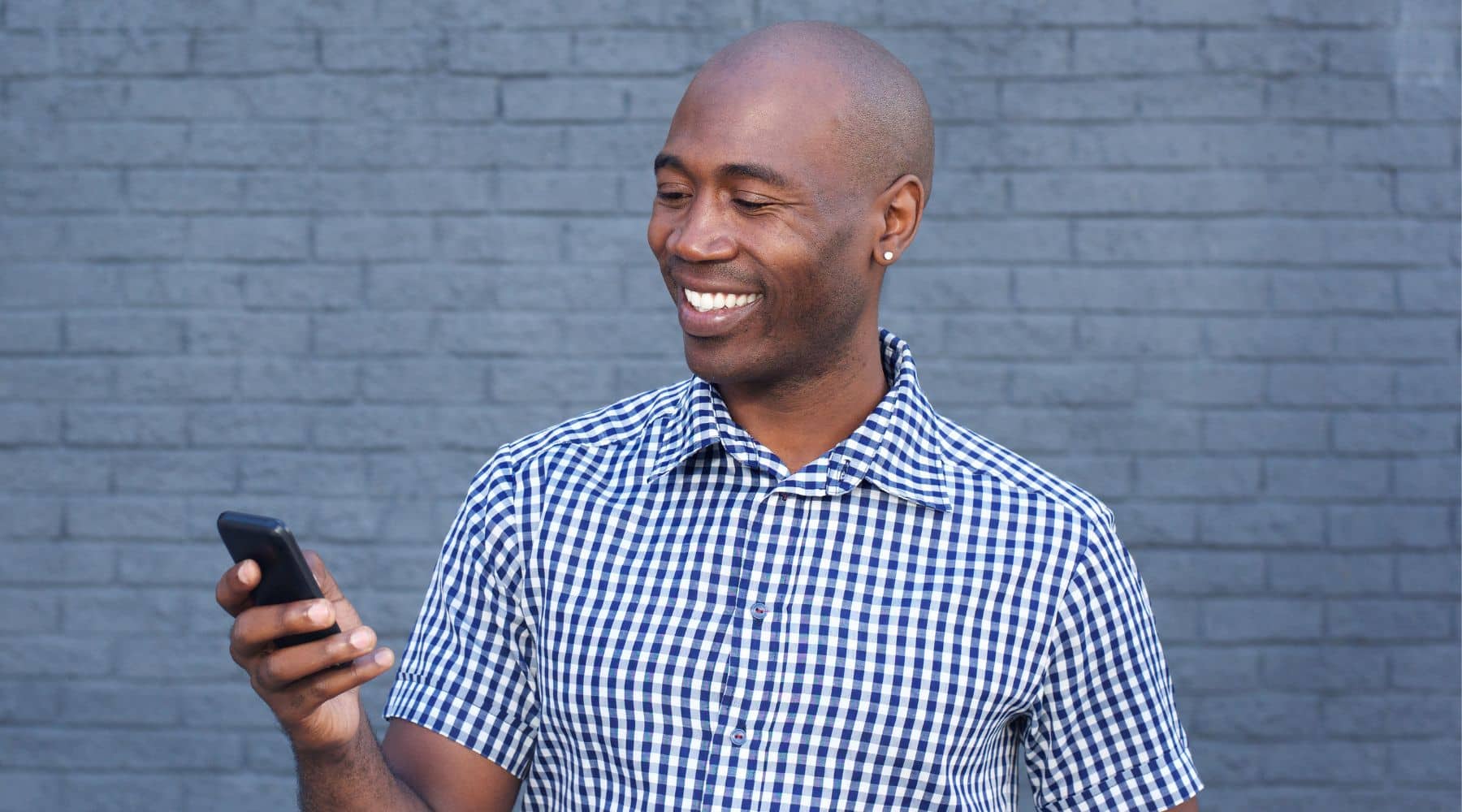 Man smiling at his phone