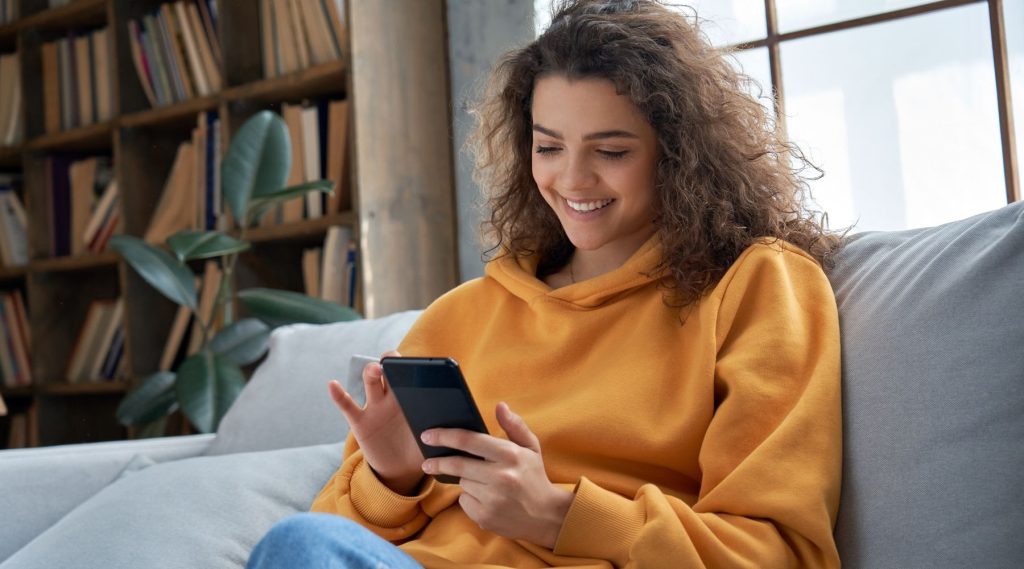 Happy woman using her phone