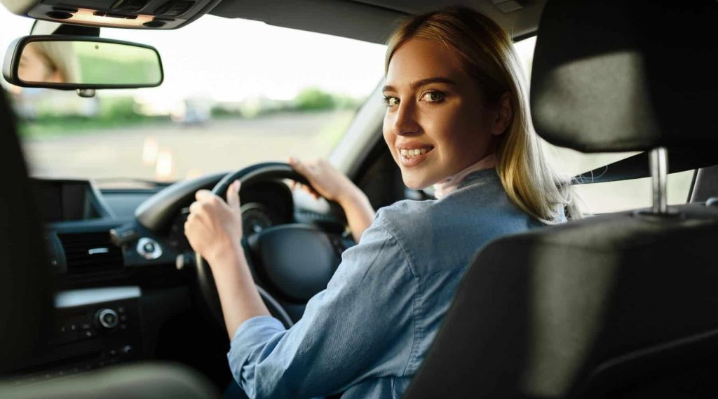A woman behind the wheel of her car