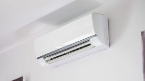 A split system reverse cycle air conditioning unit on the wall of a home