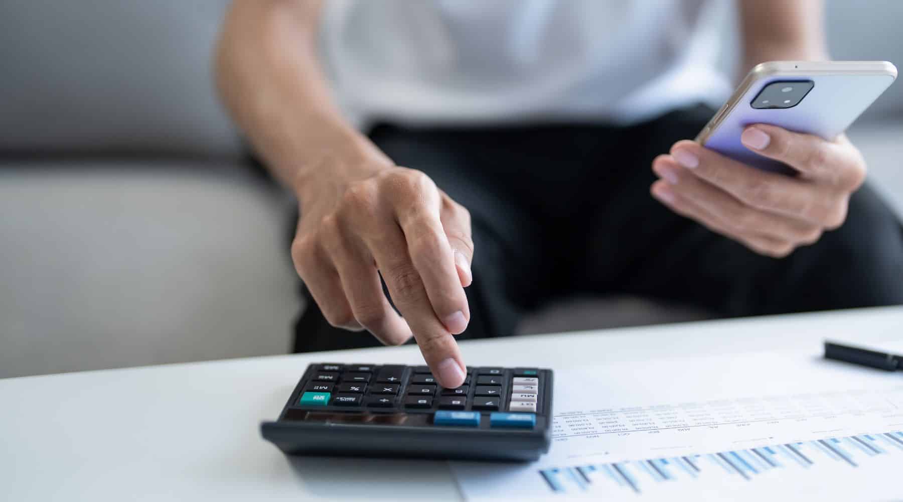 Man calculating taxes on his coffee table