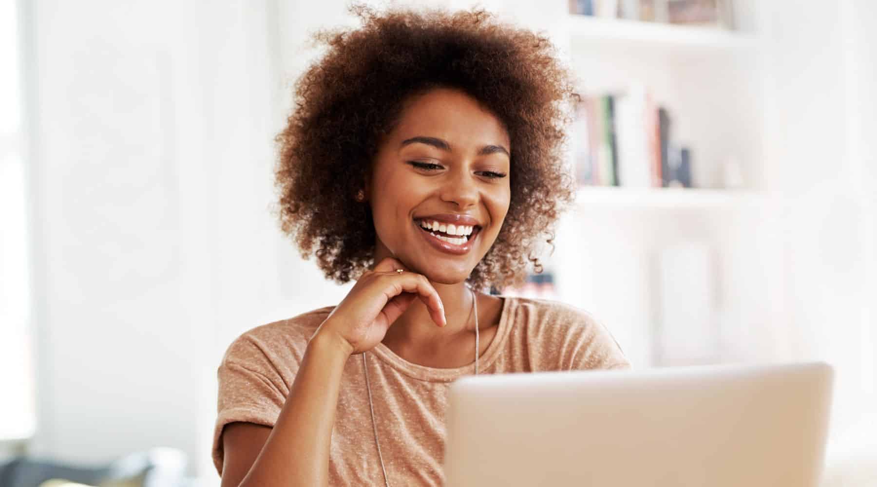Woman smiling looking at her laptop