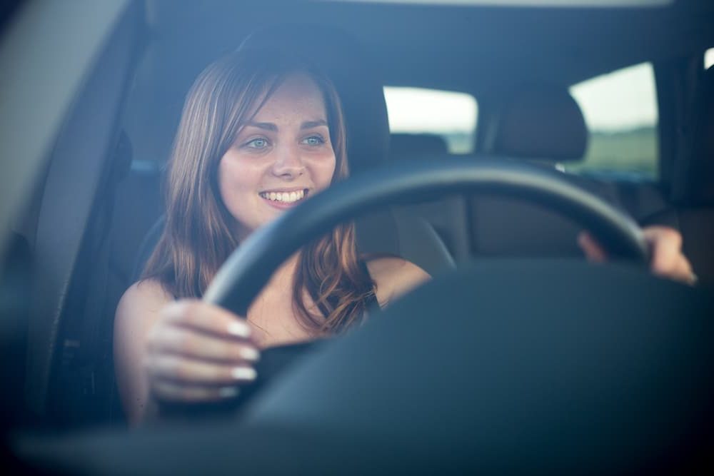 Woman behind the wheel of her rent-to-own car