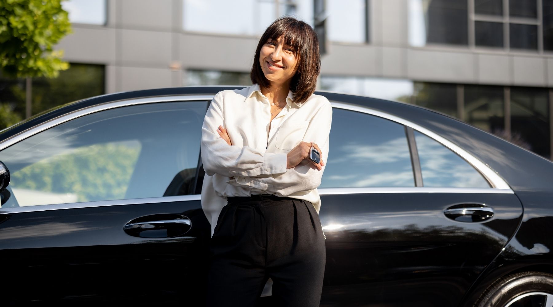 A woman standing by her car