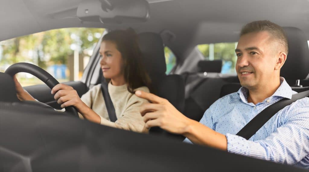 Man giving woman directions while she drives