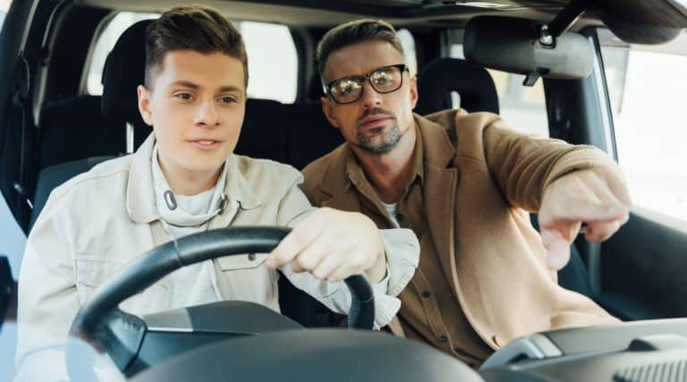 Father giving his son driving tips