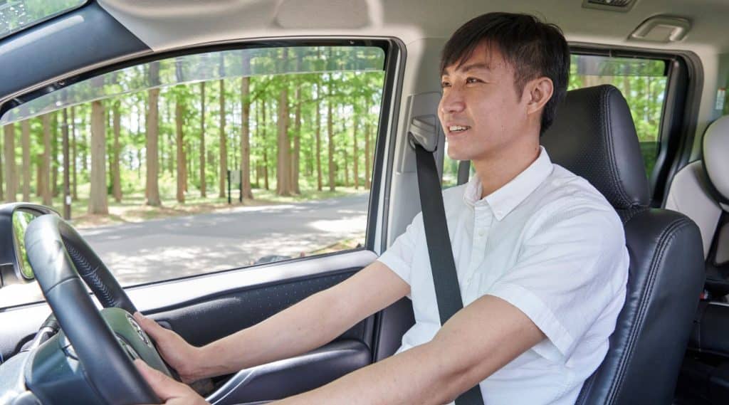 Man driving through a forest