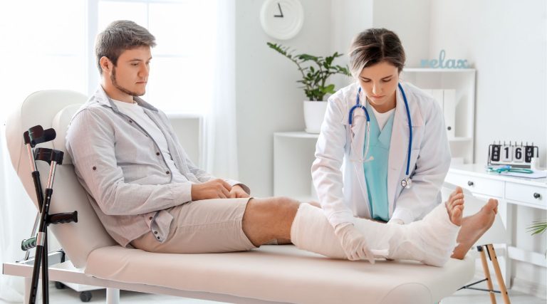 Man with broken leg visiting doctor