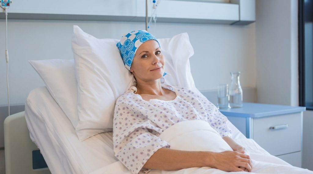 Woman with cancer in hospital bed