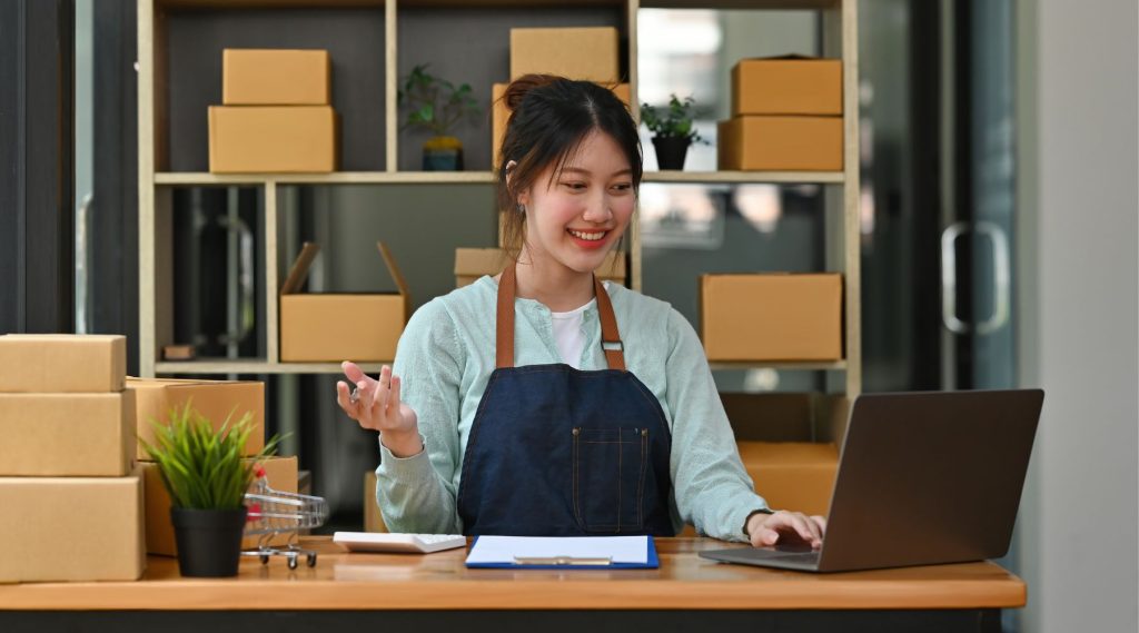 Business owner checking laptop at counter