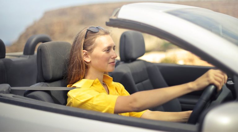 Woman driving a convertible car